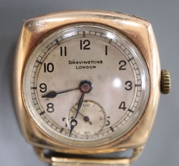 A gentlemans early 20th century 9ct gold manual wind wrist watch, retailed by Bravingtons, London,